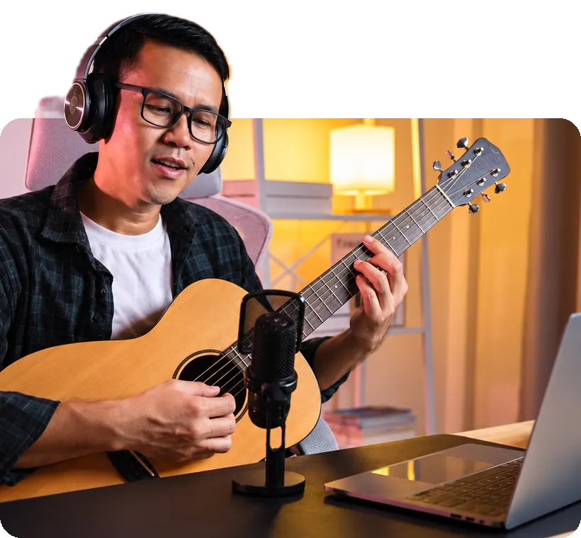 A coach teaching guitar online from his home studio.