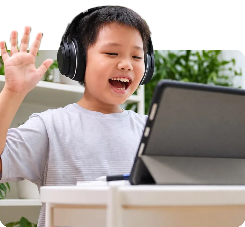 A boy waving hello to his coach on a tablet.